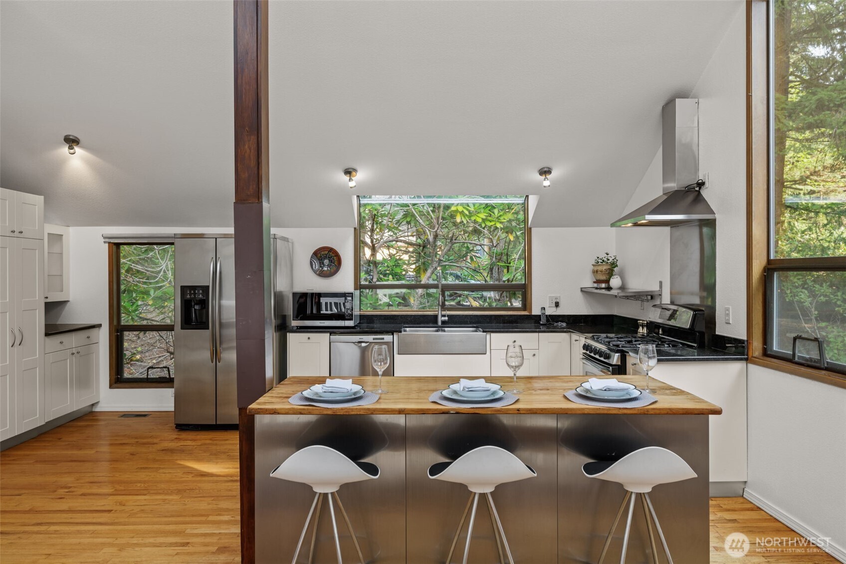 4714 175th Street Southeast Bothell, WA 98012 - Photo 18 of 40 a view of a dining room with furniture window and wooden floor
