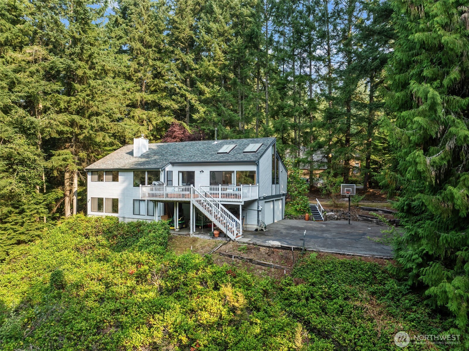 4714 175th Street Southeast Bothell, WA 98012 - Photo 2 of 40 a front view of a house with a garden and trees