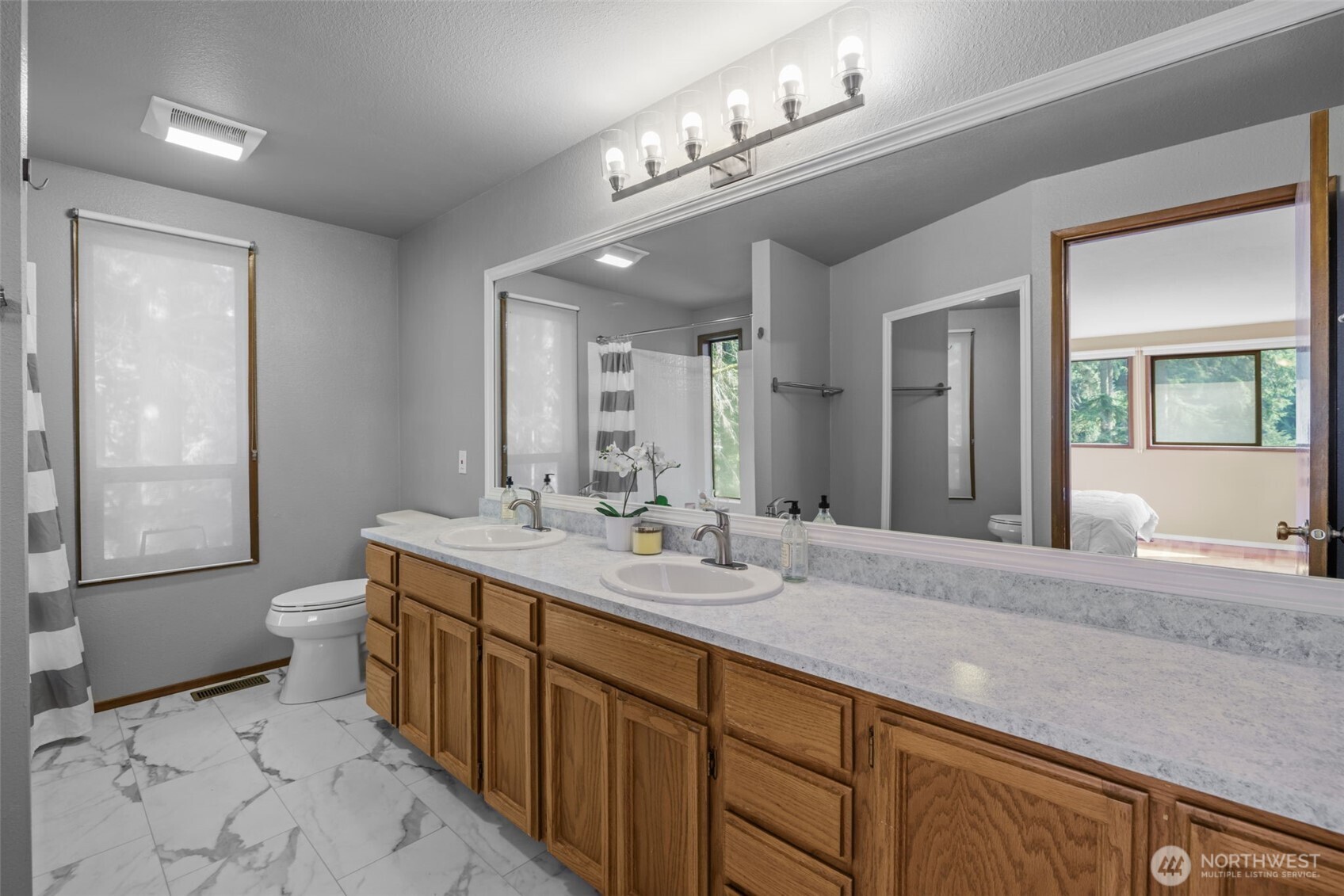 4714 175th Street Southeast Bothell, WA 98012 - Photo 27 of 40 a spacious bathroom with a granite countertop sink a toilet a mirror and shower