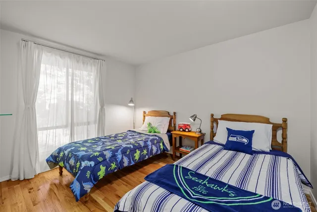 a bedroom with two beds and a dresser