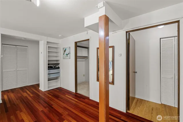 a view of closet area with wooden floor