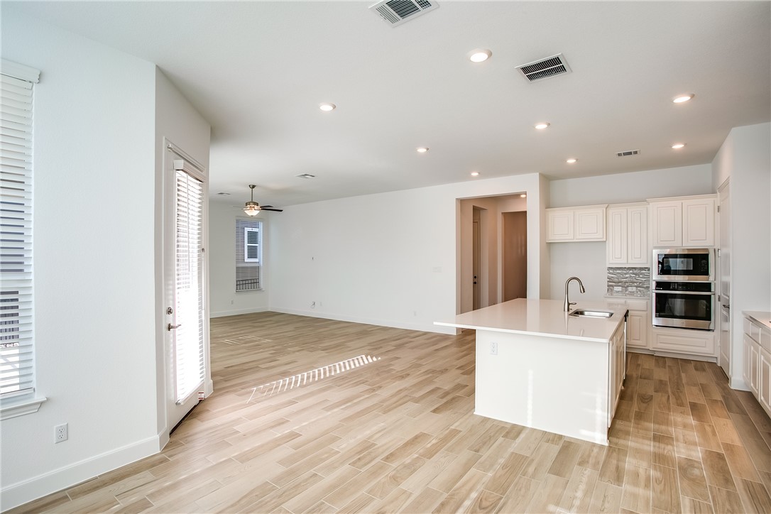 505 Affazia Lane Georgetown, TX 78628 - Photo 15 of 32 a view of kitchen with microwave a refrigerator and a stove top oven