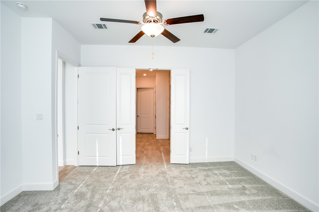 505 Affazia Lane Georgetown, TX 78628 - Photo 17 of 32 an empty room with closet and a ceiling fan
