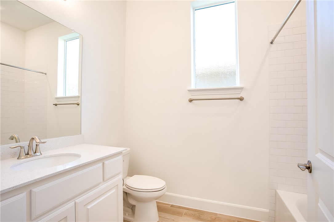 505 Affazia Lane Georgetown, TX 78628 - Photo 26 of 32 a bathroom with a sink toilet and vanity