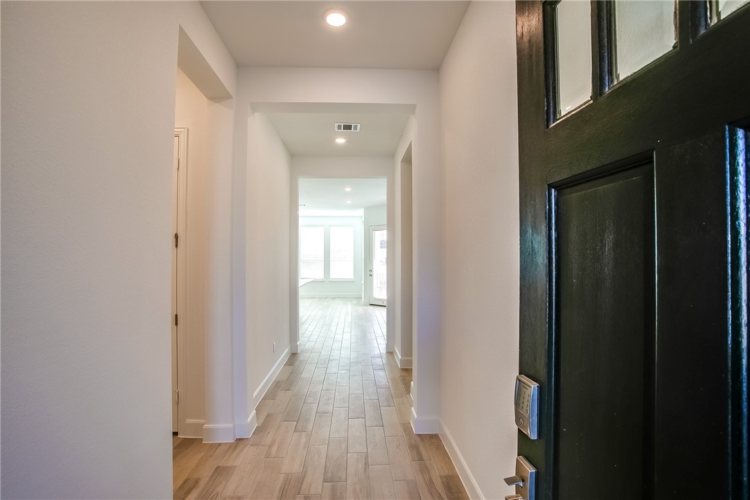 505 Affazia Lane Georgetown, TX 78628 - Photo 4 of 32 a view of a hallway with wooden floor