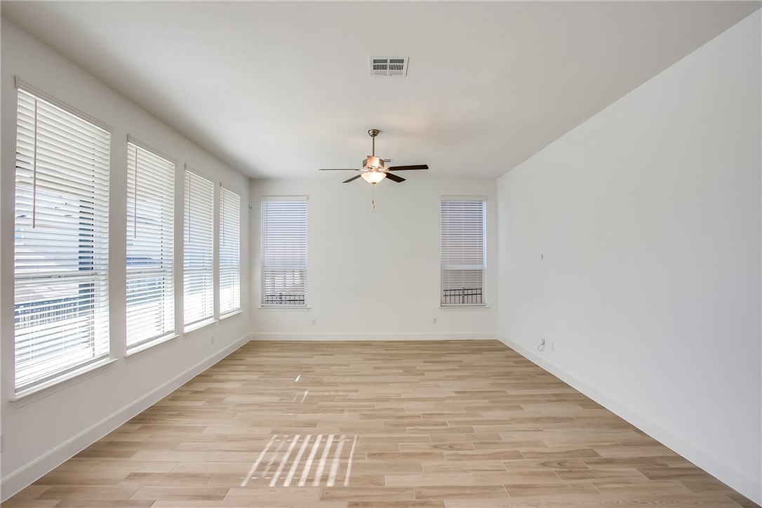 505 Affazia Lane Georgetown, TX 78628 - Photo 6 of 32 wooden floor in an empty room with a window