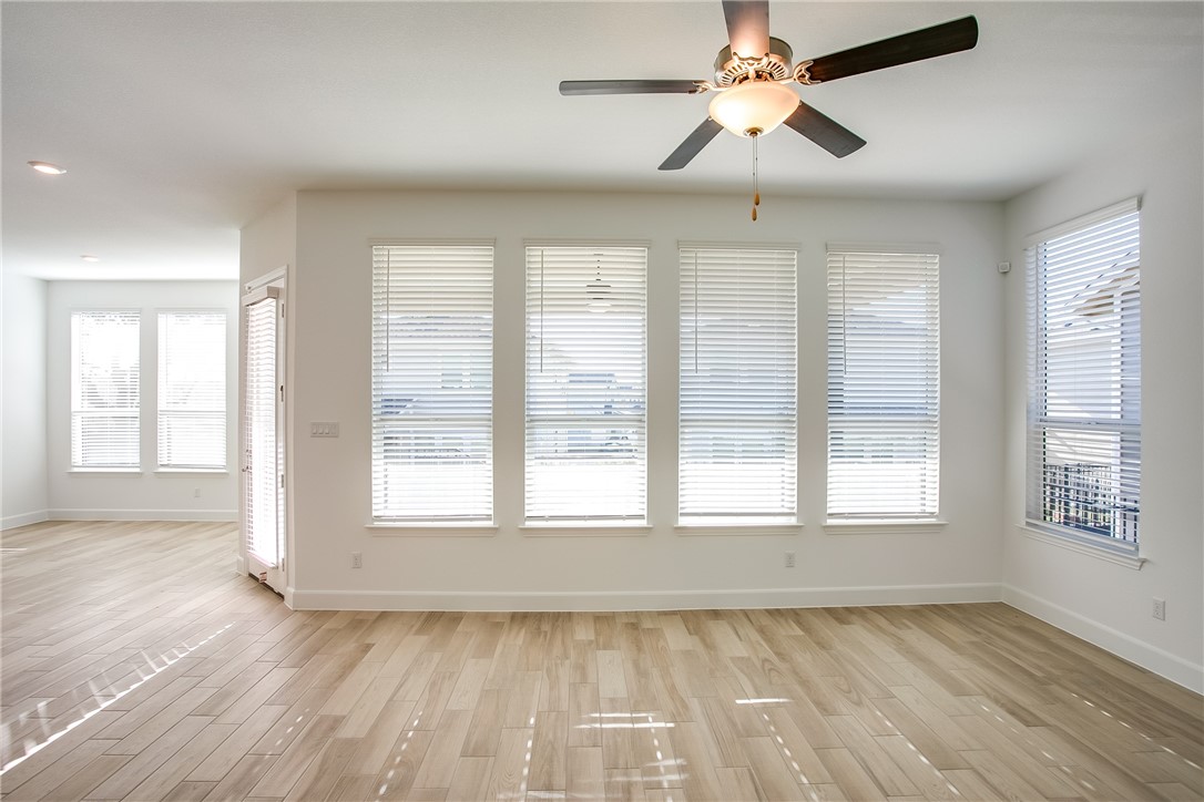 505 Affazia Lane Georgetown, TX 78628 - Photo 7 of 32 a view of an empty room with a window and wooden floor
