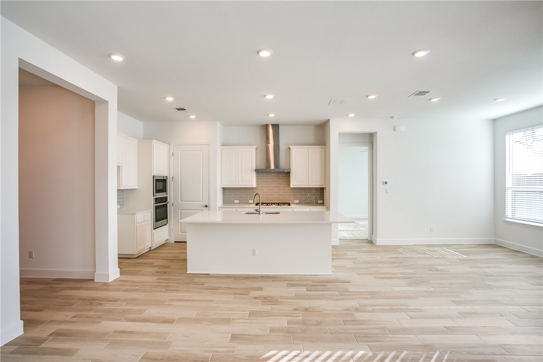 505 Affazia Lane Georgetown, TX 78628 - Photo 9 of 32 a view of kitchen with kitchen island wooden floor and center island