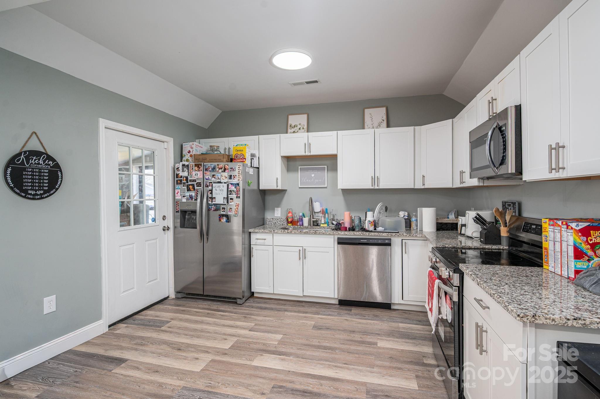 102 Guffey Road Cherryville, NC 28021 - Photo 6 of 15 a kitchen with stainless steel appliances granite countertop a refrigerator and a stove top oven