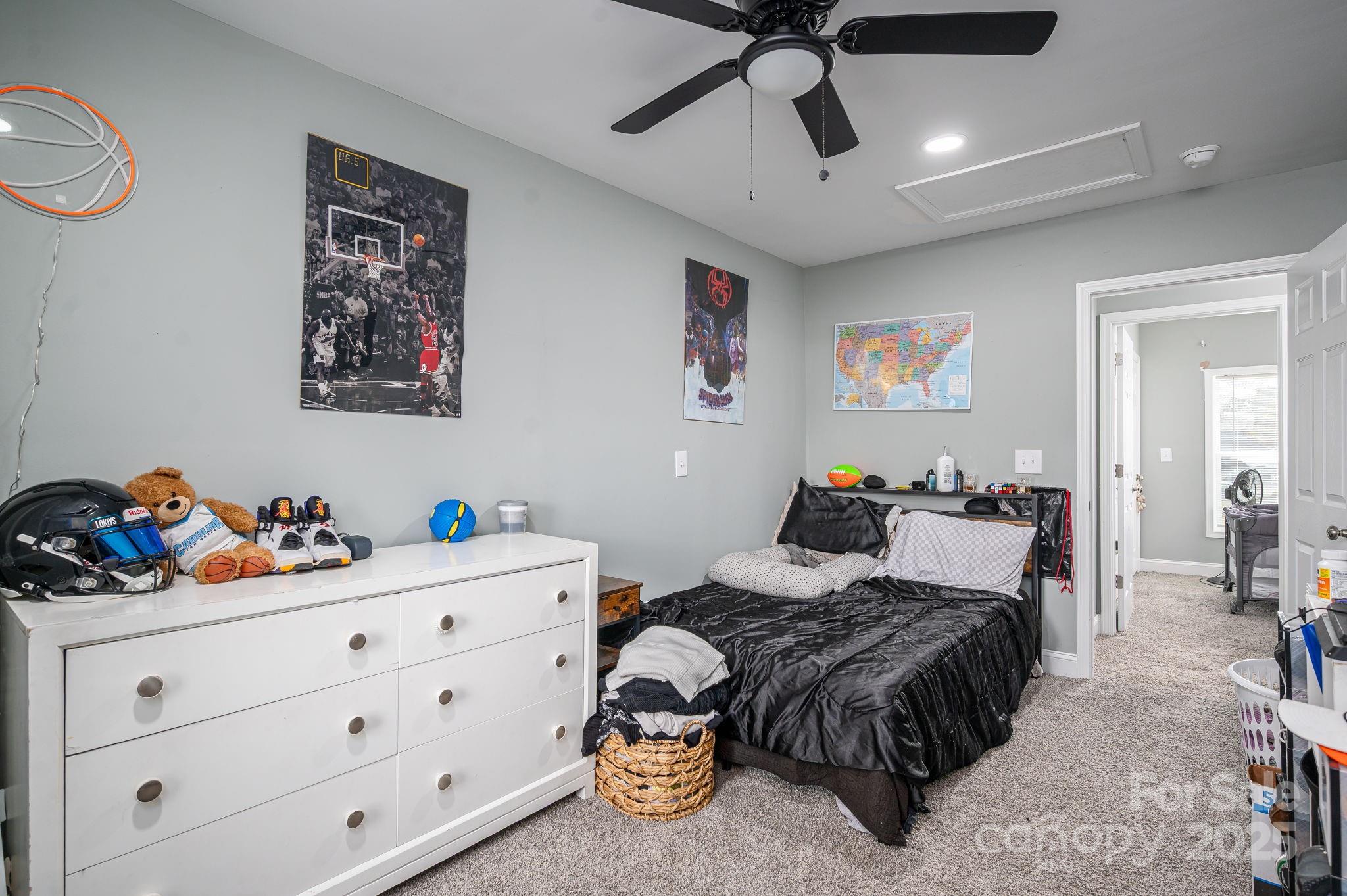 102 Guffey Road Cherryville, NC 28021 - Photo 8 of 15 a bedroom with a bed and a chandelier