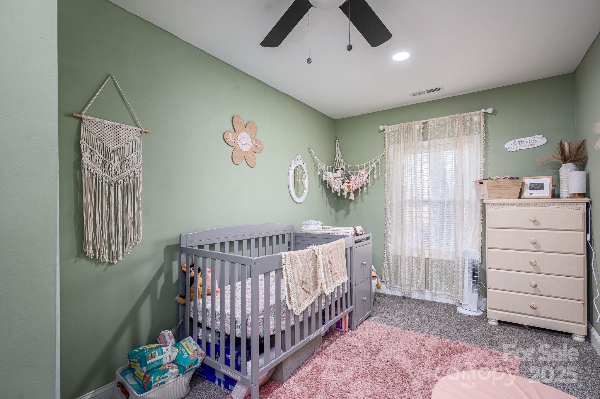 102 Guffey Road Cherryville, NC 28021 - Photo 9 of 15 a bedroom with a bed and a chandelier