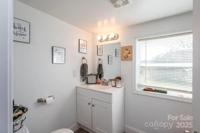 a bathroom with a sink a mirror and a window