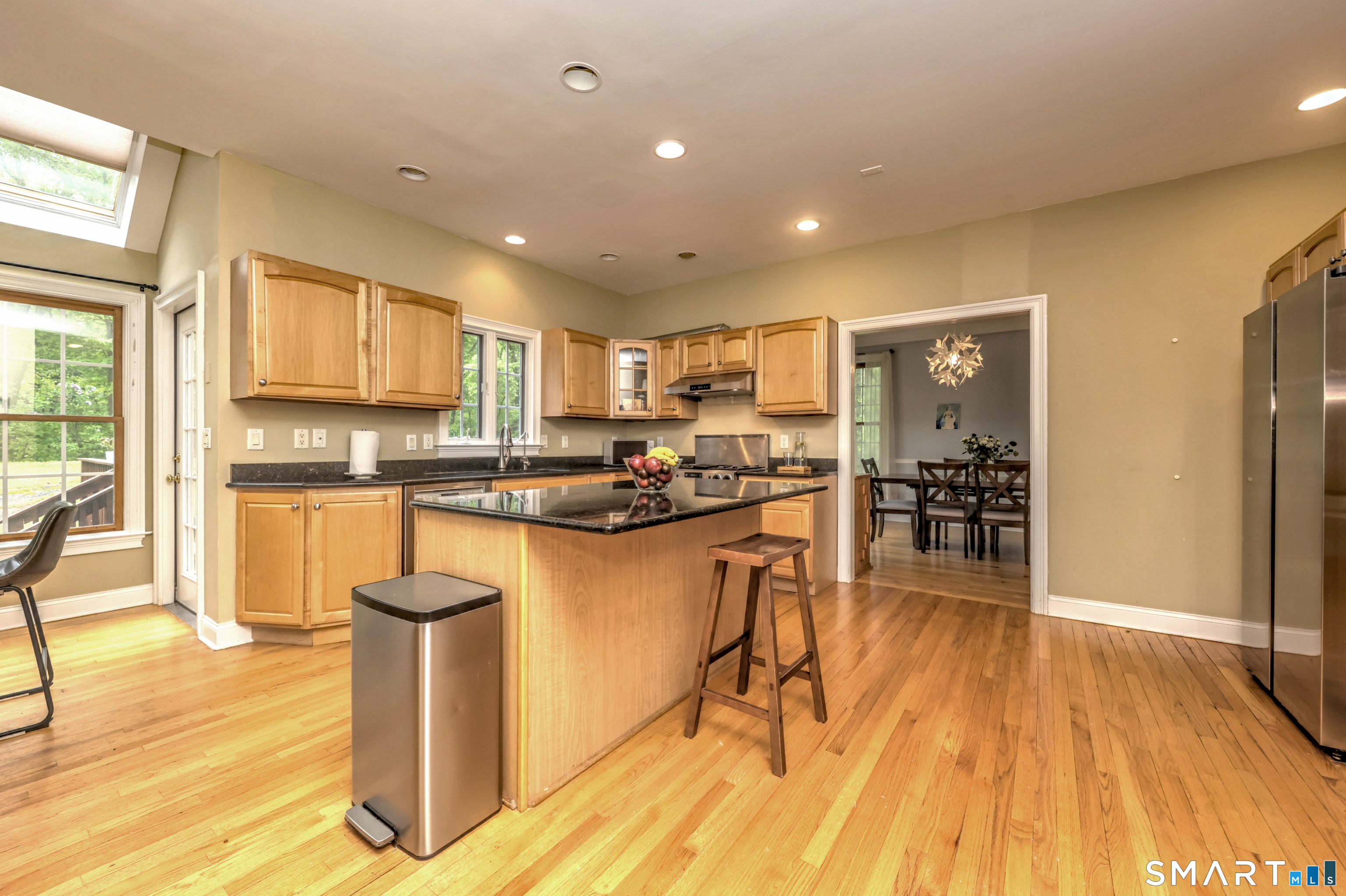 125 Peck Hill Road Woodbridge, CT 06525 - Photo 11 of 40 a kitchen with stainless steel appliances granite countertop a refrigerator a stove top oven and a sink
