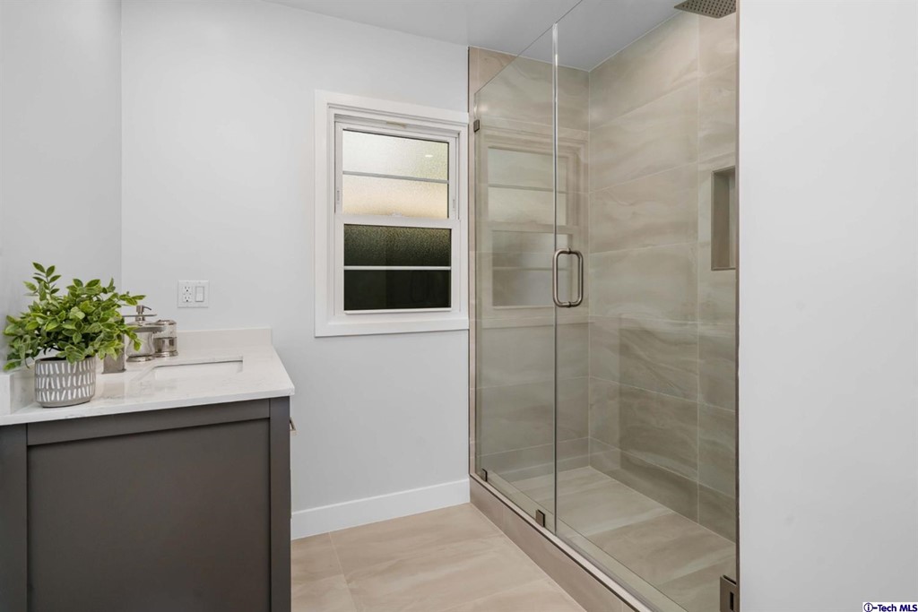 3840 Mayfair Drive Pasadena, CA 91107 - Photo 23 of 43 a bathroom with a shower sink and mirror