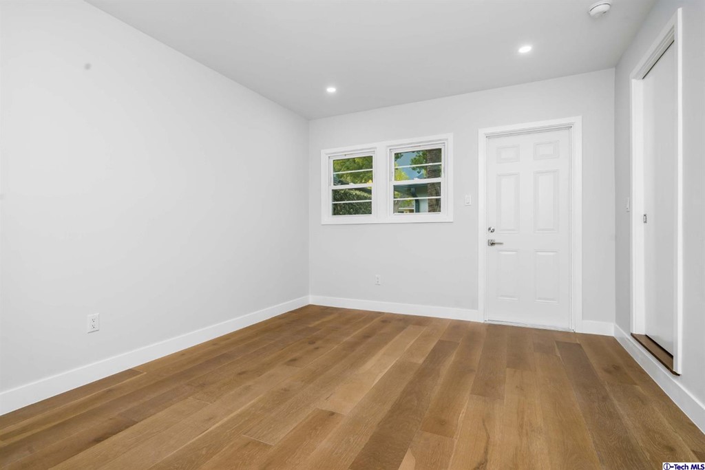 3840 Mayfair Drive Pasadena, CA 91107 - Photo 31 of 43 an empty room with wooden floor and windows