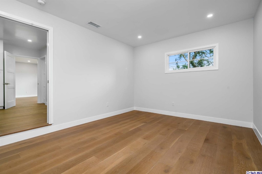 3840 Mayfair Drive Pasadena, CA 91107 - Photo 32 of 43 an empty room with wooden floor and windows