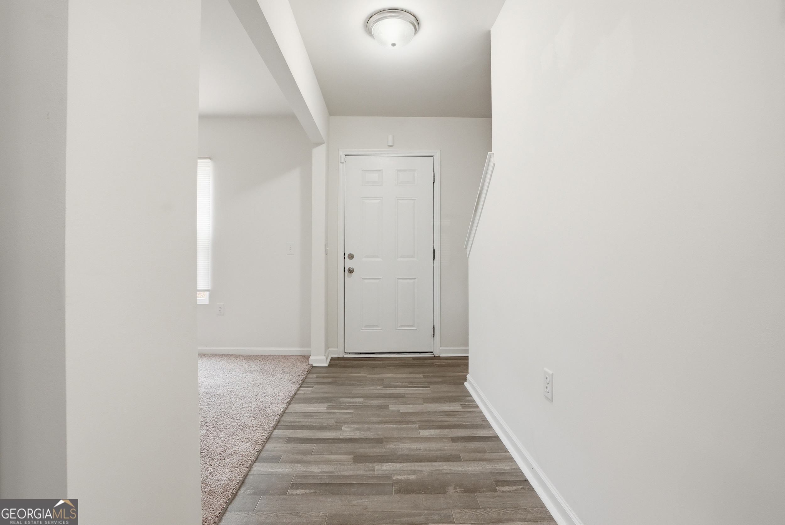 225 Rendell Lane Hinesville, GA 31313 - Photo 4 of 33 a view of a hallway with wooden floor