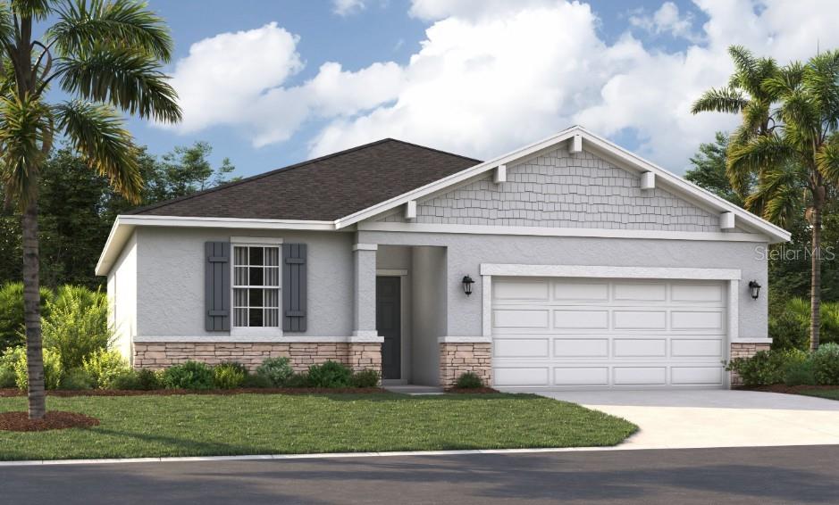 a front view of a house with a garden and yard