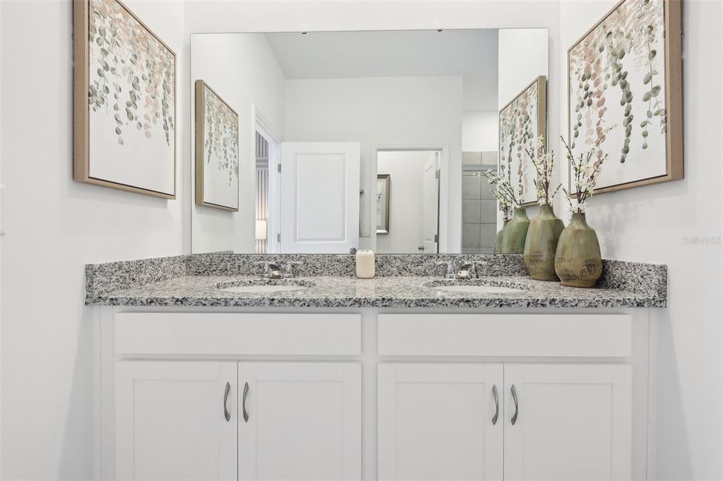 1885 Shadow Box Bend St. Cloud, FL 34771 - Photo 32 of 45 a bathroom with a granite countertop sink and a mirror