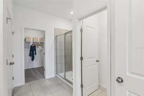 a bathroom with a shower and a glass door