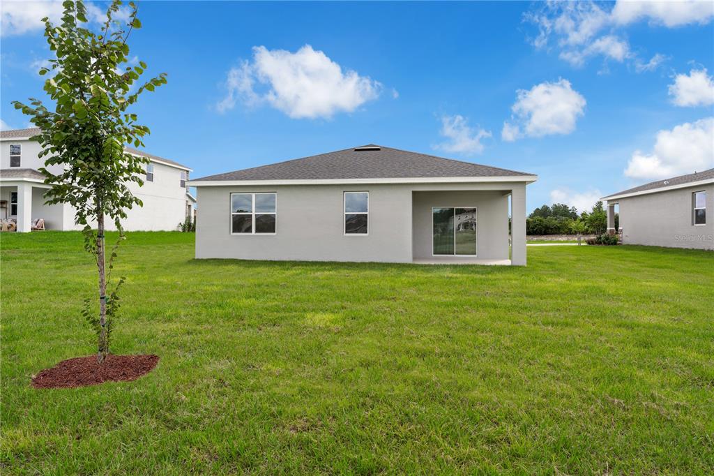 1885 Shadow Box Bend St. Cloud, FL 34771 - Photo 39 of 45 a front view of a house with a yard
