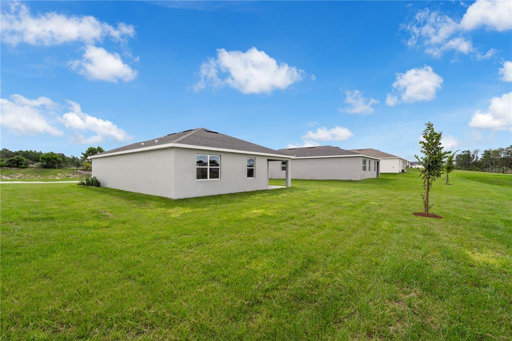 1885 Shadow Box Bend St. Cloud, FL 34771 - Photo 41 of 45 a front view of house with garden