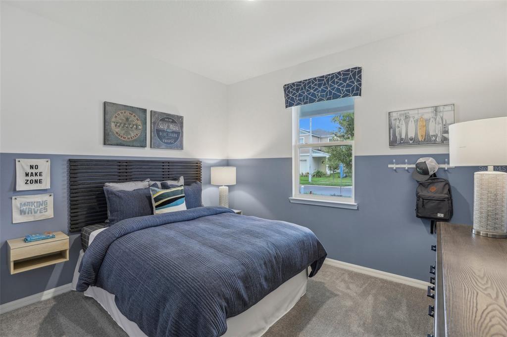 1885 Shadow Box Bend St. Cloud, FL 34771 - Photo 6 of 45 a bedroom with a bed and wooden floor