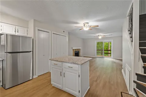 a view of a kitchen with a sink a refrigerator and cabinet
