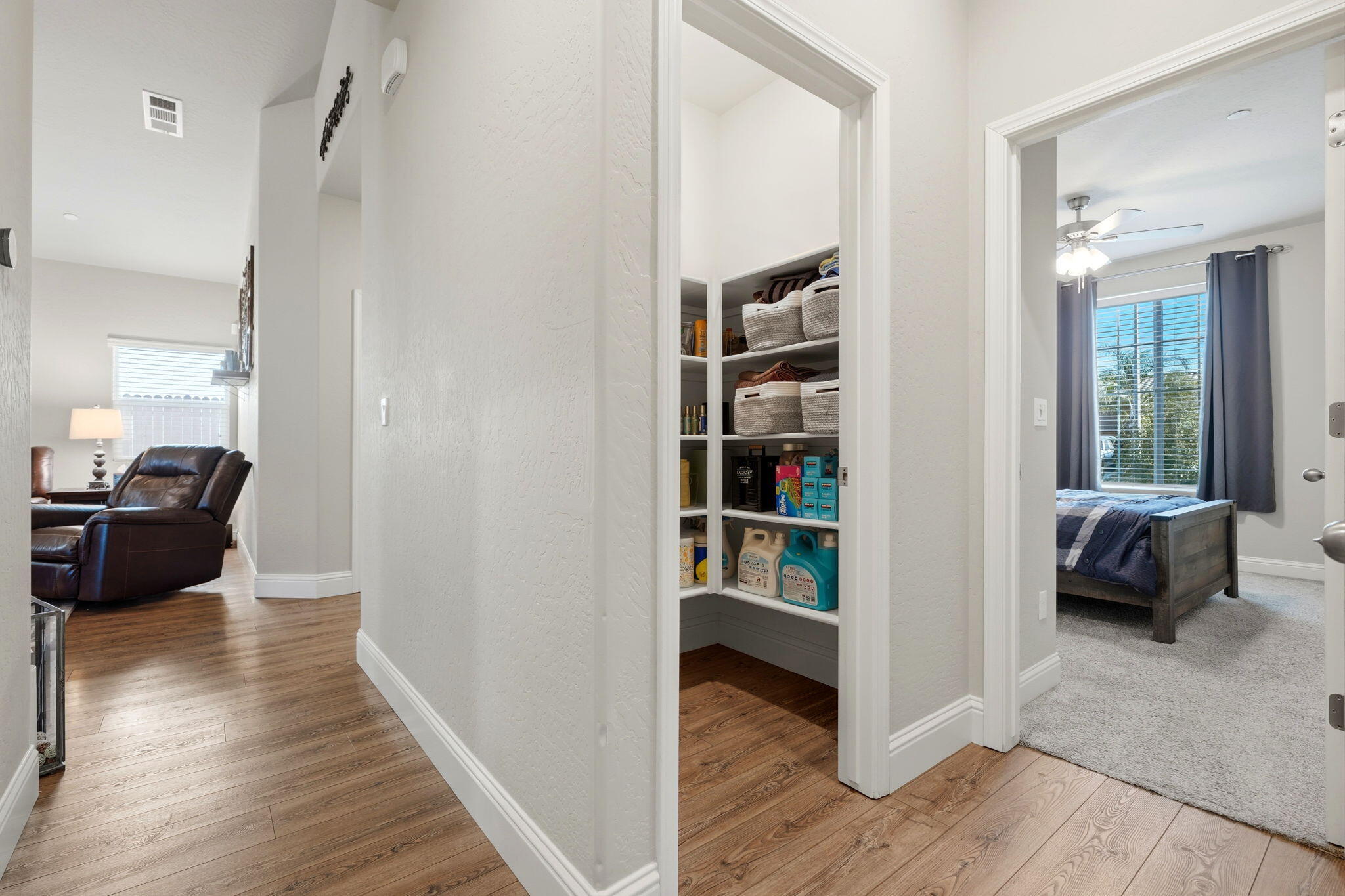 756 Strada Street Lemoore, CA 93245 - Photo 22 of 53 a view of a bedroom with wooden floor and furniture