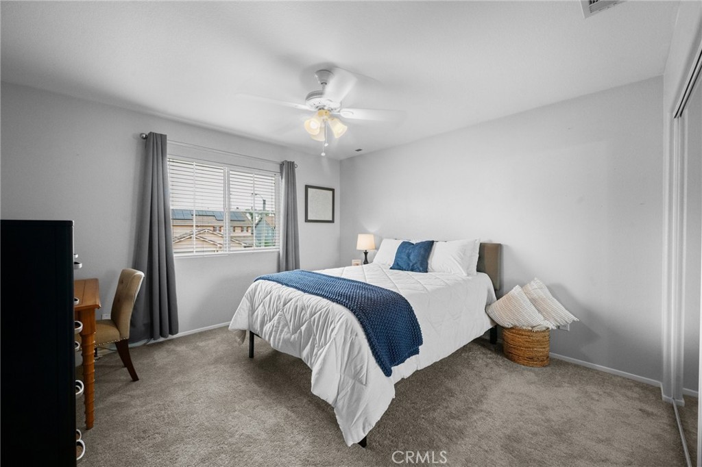 7220 Cumberland Place Rancho Cucamonga, CA 91739 - Photo 27 of 41 Bright southeast-facing bedroom with plush carpet and a ceiling fan.