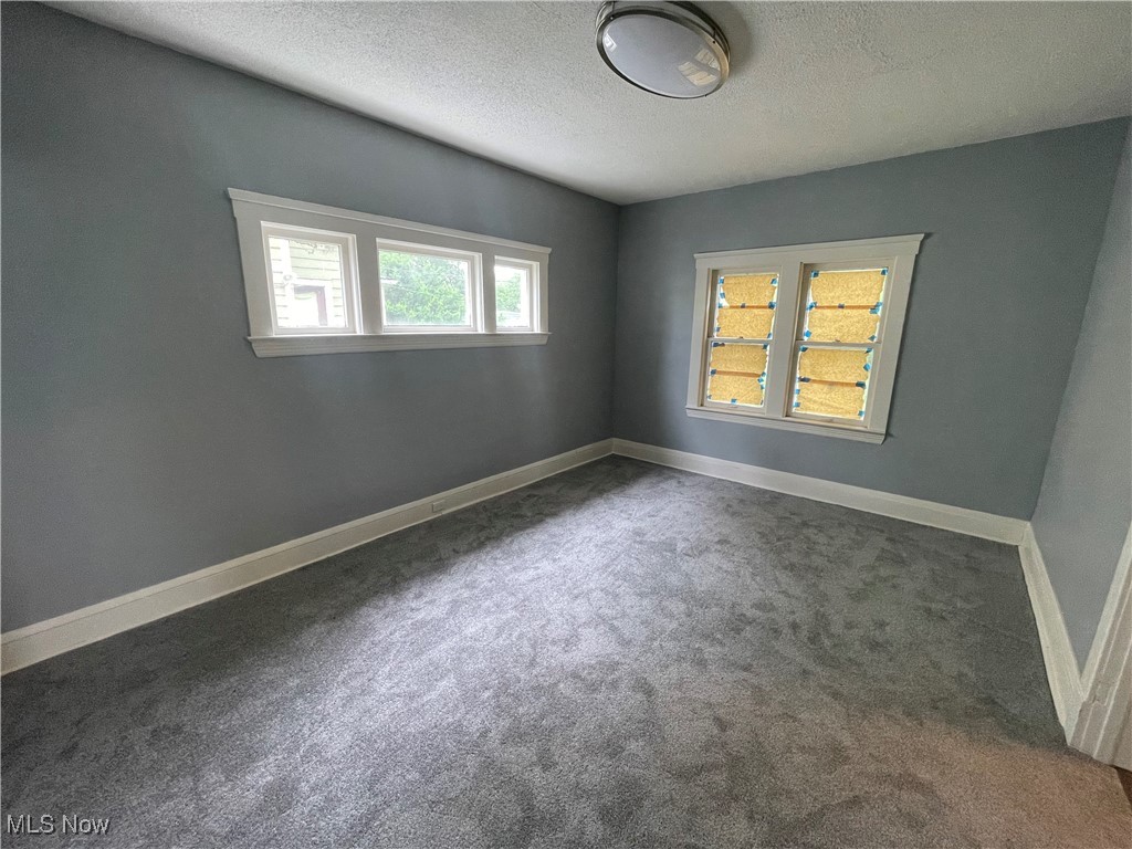 912 Yellowstone Road Cleveland Heights, OH 44121 - Photo 14 of 35 Carpeted spare room featuring a textured ceiling and baseboards