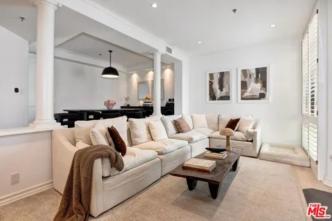 a living room with furniture and a night stand