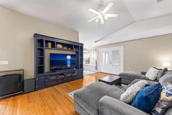 a living room with furniture and a flat screen tv
