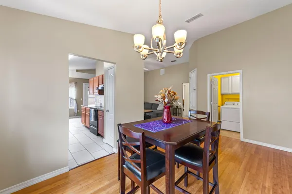 a view of a dining room with furniture and wooden floor