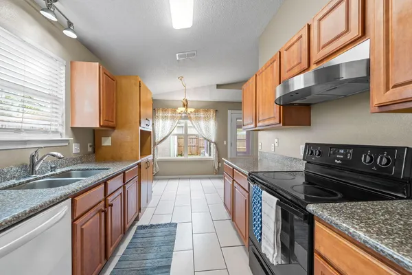 a kitchen with stainless steel appliances granite countertop a stove and a sink