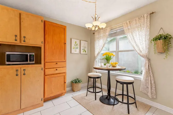 a view of a dining room with furniture and a chandelier