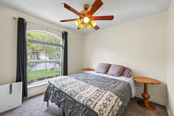 a bedroom with a bed and a chandelier