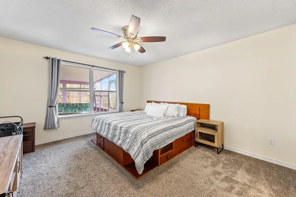 a spacious bedroom with a bed and a table in it