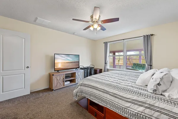 a bedroom with a bed and a flat screen tv