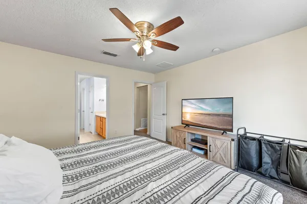 a bedroom with a bed and a flat screen tv