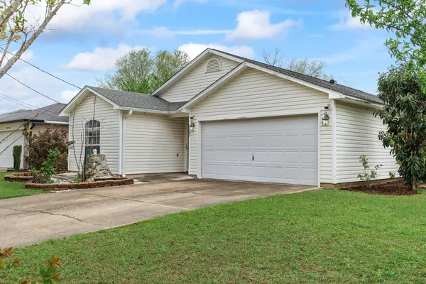 a front view of house with yard and trees