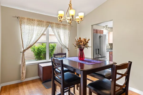 a view of a dining room with furniture wooden floor and chandelier