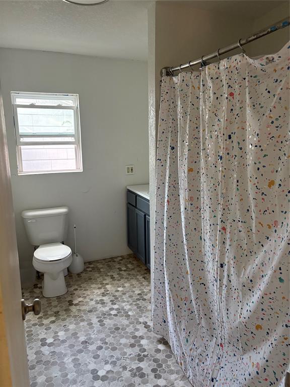 616 Breckenridge Highway Ranger, TX 76470 - Photo 11 of 16 a bathroom with a toilet and a shower