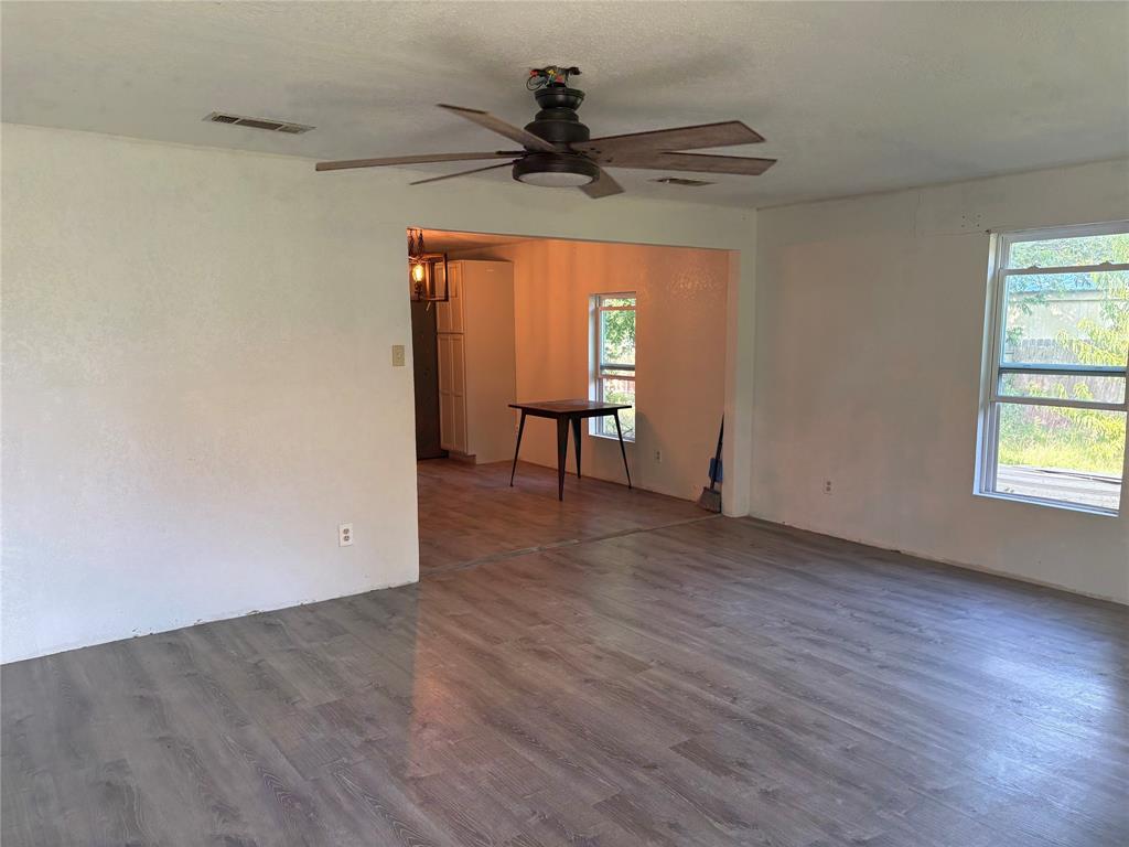 616 Breckenridge Highway Ranger, TX 76470 - Photo 8 of 16 wooden floor in an empty room with a window