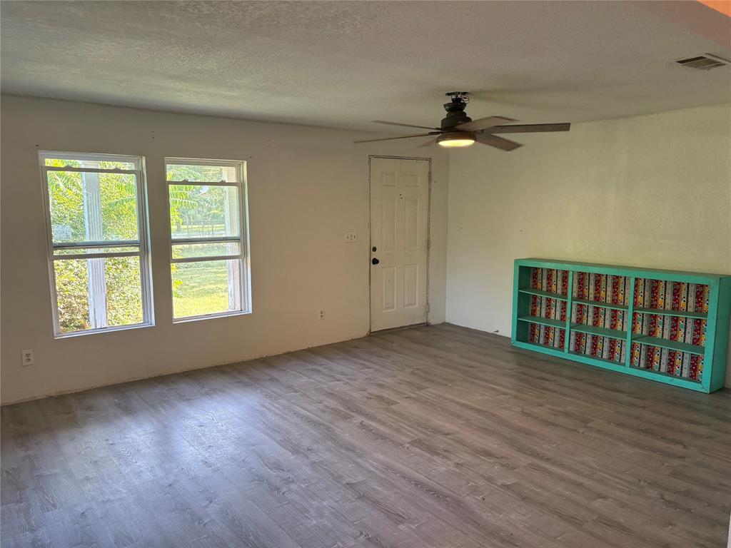616 Breckenridge Highway Ranger, TX 76470 - Photo 9 of 16 wooden floor in an empty room with a window