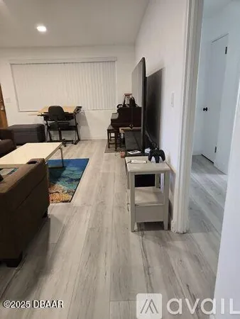 a living room with a flat screen tv and a couch