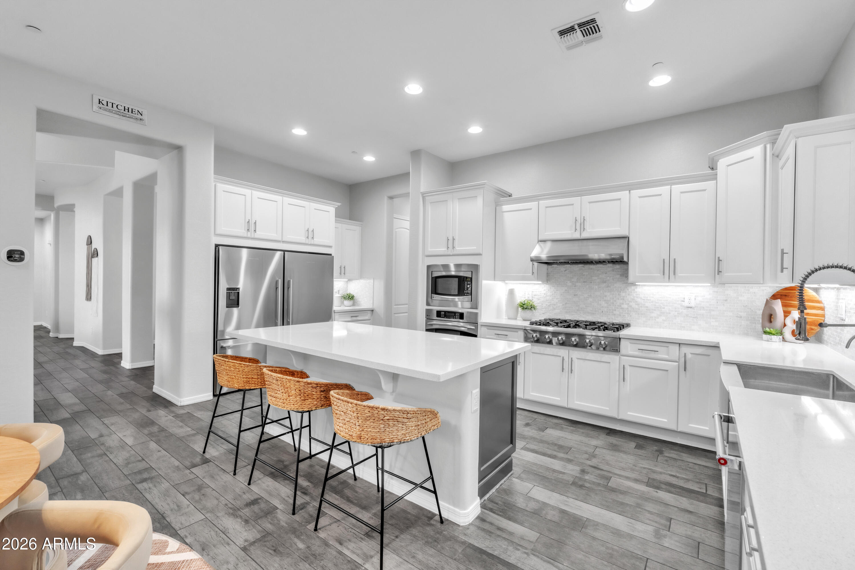 1615 West Red Fox Road Phoenix, AZ 85085 - Photo 23 of 64 a kitchen with stainless steel appliances granite countertop a stove a sink a refrigerator and white cabinets with wooden floor