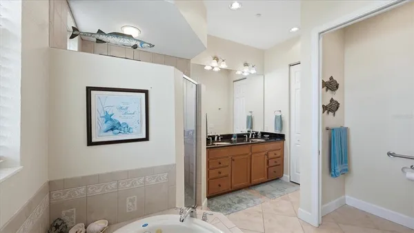 a bedroom with a bed and painting on the wall