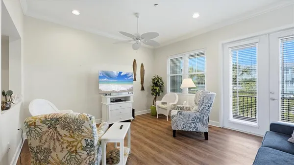 a living room with furniture and a wooden floor