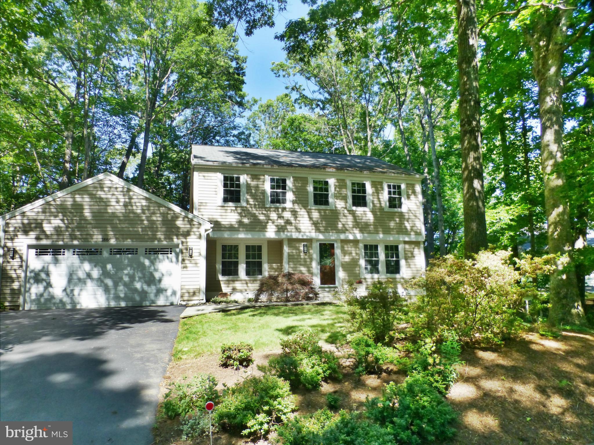 1866 Post Oak Trail Reston, VA 20191 - Photo 2 of 19 front view of a house with a yard